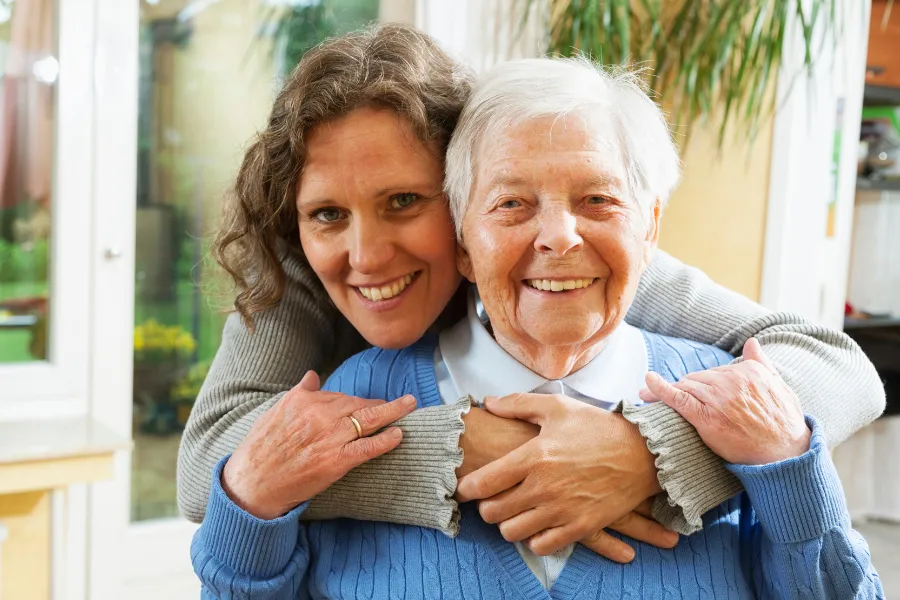 Younger woman smiling with older woman