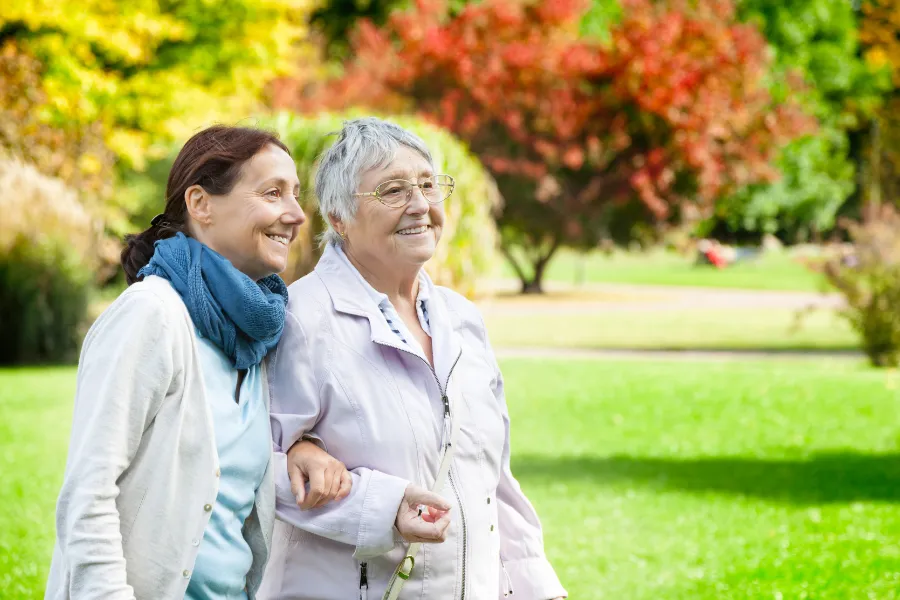 Two senior woman walking outdoors