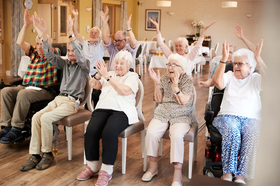Group of seniors with hands raised having a good time
